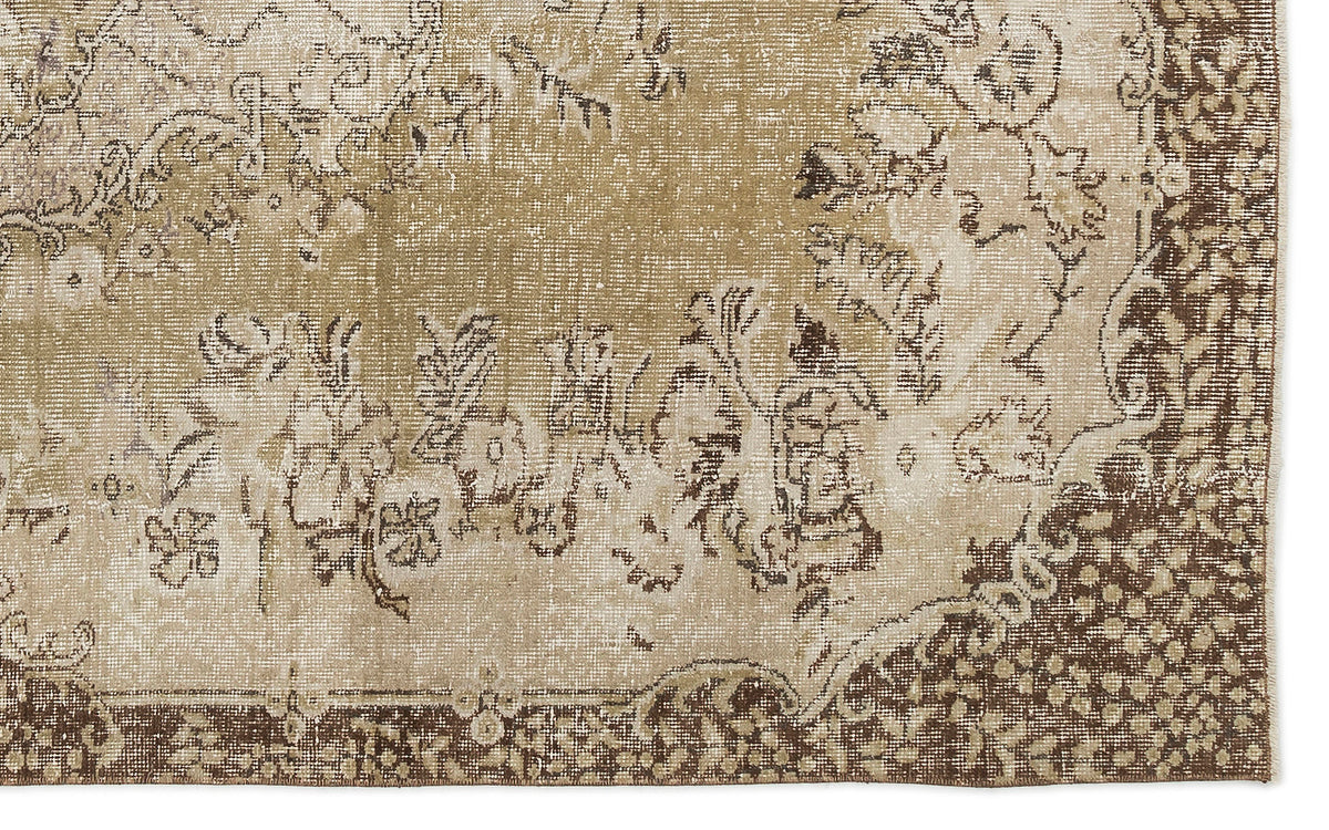 Tan and brown vintage-style rug with a distressed floral medallion pattern and a detailed geometric border.