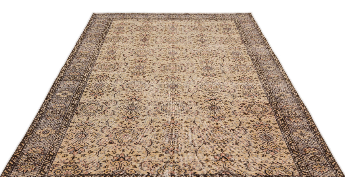Beige and brown vintage-style rug with a distressed floral medallion pattern and a wide decorative border.