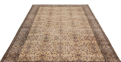 Load image 1 in gallery view. Beige and brown vintage-style rug with a distressed floral medallion pattern and a wide decorative border.