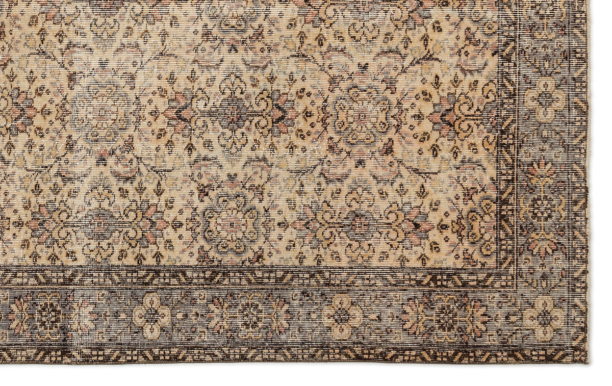 Beige and brown traditional rug with a distressed floral medallion pattern and a dark border.