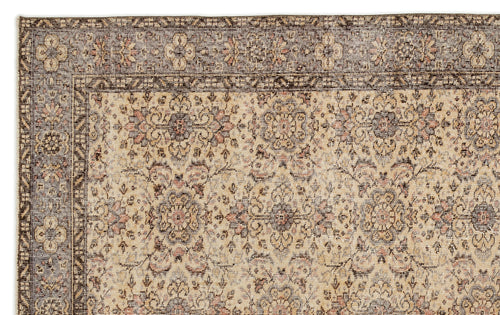 Load image 1 in gallery view. Beige and brown traditional rug with a distressed floral medallion pattern and a detailed geometric border.
