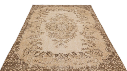 Load image 1 in gallery view. Beige and brown vintage-style rug with a central floral medallion and ornate border on a white background.
