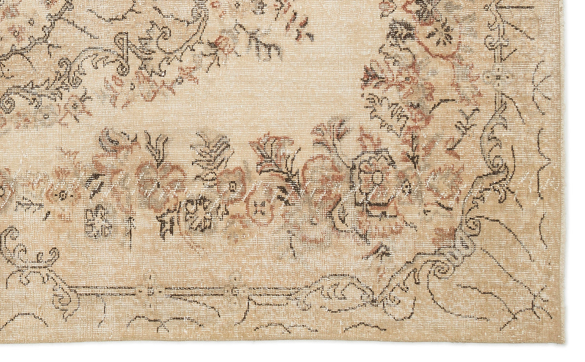 Beige vintage-style rug with a distressed floral medallion pattern in muted brown, rust, and charcoal outlines.