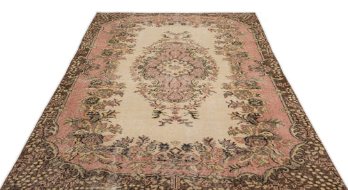 Load image 1 in gallery view. Distressed beige, pink, and brown rug with a central floral medallion and ornate botanical border.