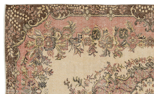 Load image 1 in gallery view. Distressed vintage-style rug with a floral medallion pattern in muted brown, dusty pink, and cream.