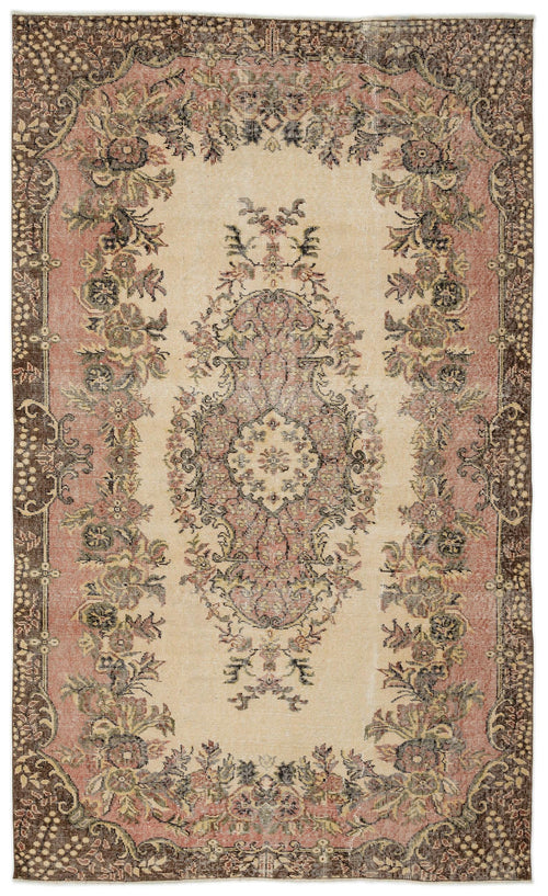 Load image 1 in gallery view. Distressed beige, pink, and brown vintage-style rug with a central floral medallion and ornate border.