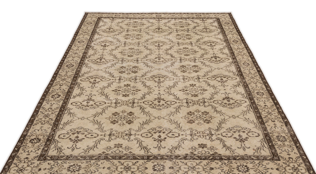 Beige and dark brown area rug with a traditional floral medallion pattern and a decorative border.