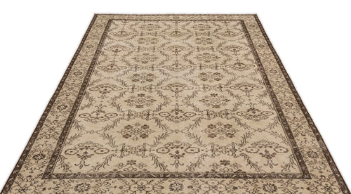 Load image 1 in gallery view. Beige and dark brown area rug with a traditional floral medallion pattern and a decorative border.