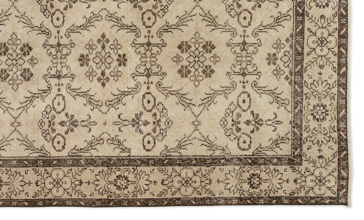 Beige and dark brown rug with a traditional floral medallion pattern and a decorative border.