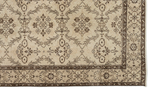 Load image 1 in gallery view. Beige and dark brown rug with a traditional floral medallion pattern and a decorative border.