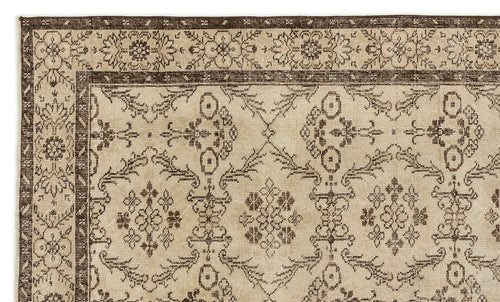 Load image 1 in gallery view. Beige and dark brown rug with a traditional floral medallion border and repeating geometric botanical pattern.