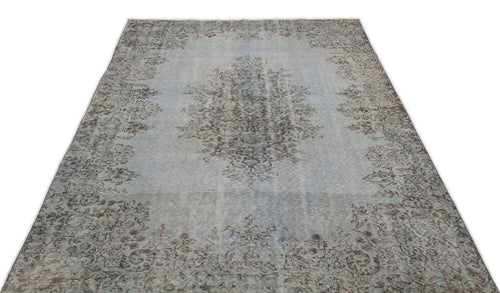 Load image 1 in gallery view. Light blue and grey distressed rug with a central floral medallion and ornate border pattern on a white background.