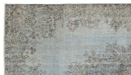 Load image 1 in gallery view. Light blue and grey distressed rug with a faded floral medallion pattern.