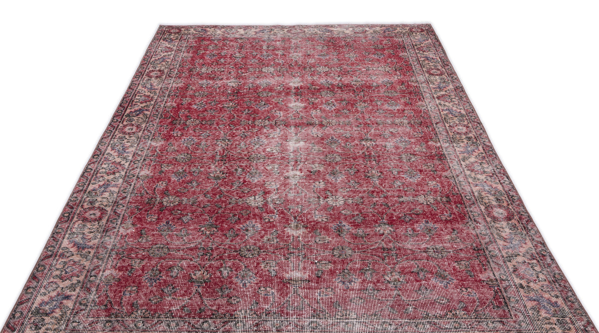 Distressed red and cream traditional rug with an intricate floral medallion pattern on a white background.