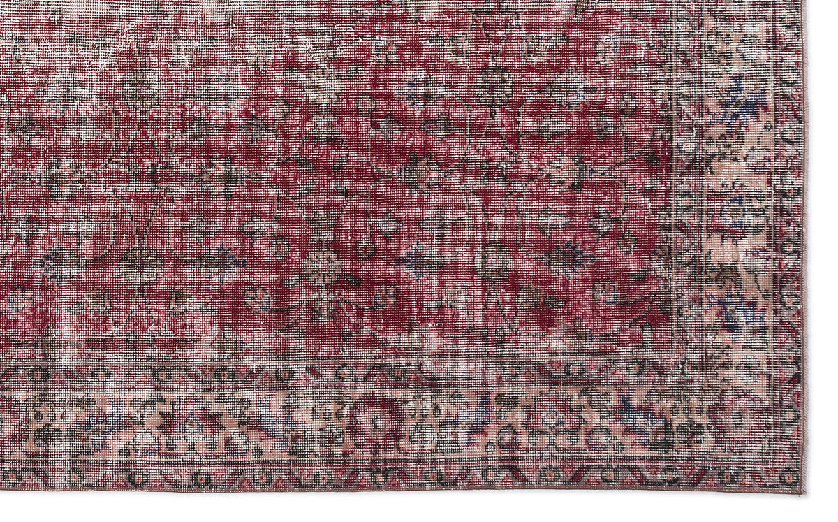 Deep red traditional rug with a distressed floral pattern and a beige border on a white background.