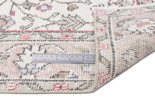 Load image 1 in gallery view. Cream, pink, and grey traditional rug with a floral pattern, shown with a metal ruler for scale on a white background.
