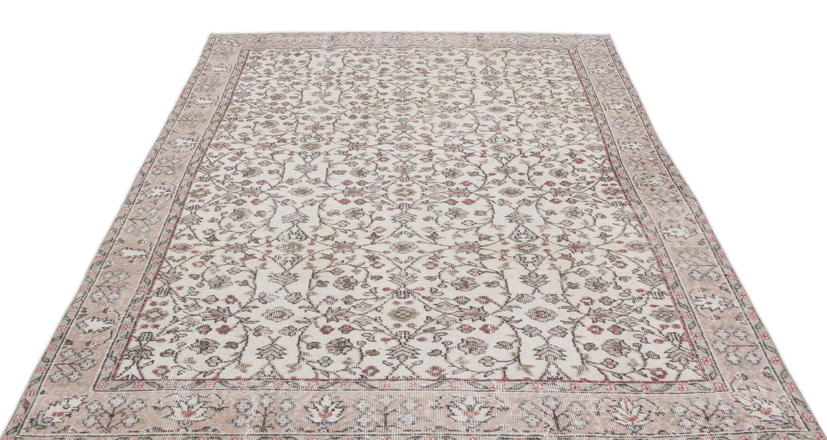 Cream and beige vintage-style rug with a distressed floral vine pattern and a wide decorative border.