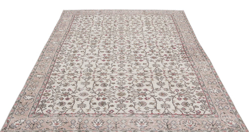 Load image 1 in gallery view. Cream and beige vintage-style rug with a distressed floral vine pattern and a wide decorative border.