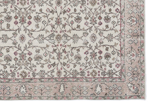 Load image 1 in gallery view. Cream rug with a distressed floral vine pattern in muted pink, grey, and brown, featuring a wide decorative border.