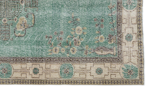 Load image 1 in gallery view. Teal and beige rug with a distressed floral center and a geometric border featuring circular motifs.