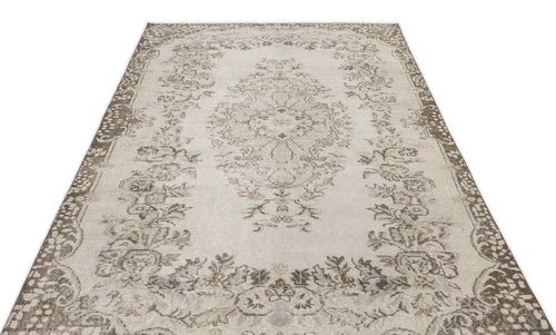 Load image 1 in gallery view. Beige and brown vintage-style rug with a central floral medallion and ornate border on a white background.
