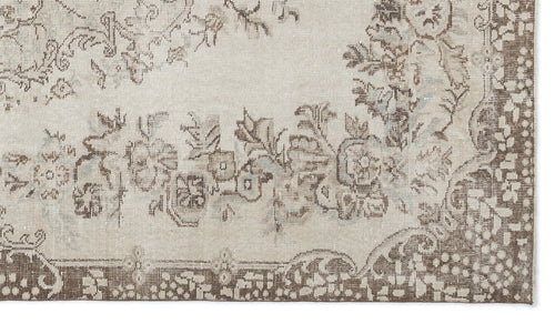 Load image 1 in gallery view. Beige and brown distressed rug with a traditional floral medallion pattern on a white background.