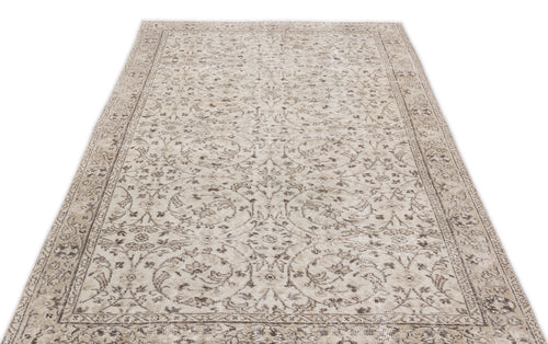 Load image 1 in gallery view. Beige and taupe vintage-style rug with a distressed floral medallion pattern and a detailed border on a white background.