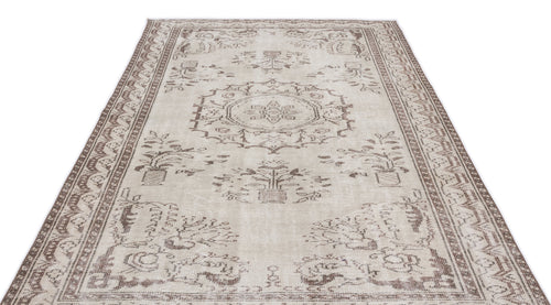 Load image 1 in gallery view. Beige and brown vintage-style rug with a central medallion and floral motifs, isolated on a white background.
