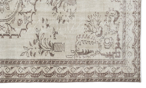 Load image 1 in gallery view. Beige and brown rug with a distressed traditional floral pattern and a geometric border.
