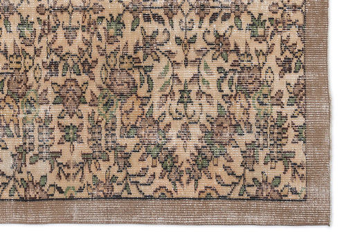Load image 1 in gallery view. Tan and brown rug with a distressed floral pattern, green accents, and a solid border on a white background.