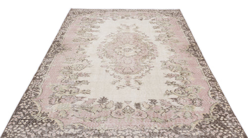 Load image 1 in gallery view. Cream, pink, and brown distressed rug with a traditional floral medallion pattern on a white background.