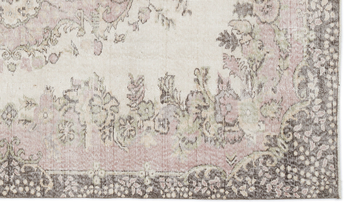 Distressed cream, dusty pink, and dark brown rug with a traditional floral medallion pattern.