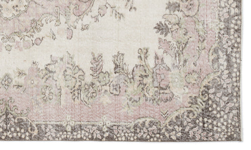 Load image 1 in gallery view. Distressed cream, dusty pink, and dark brown rug with a traditional floral medallion pattern.