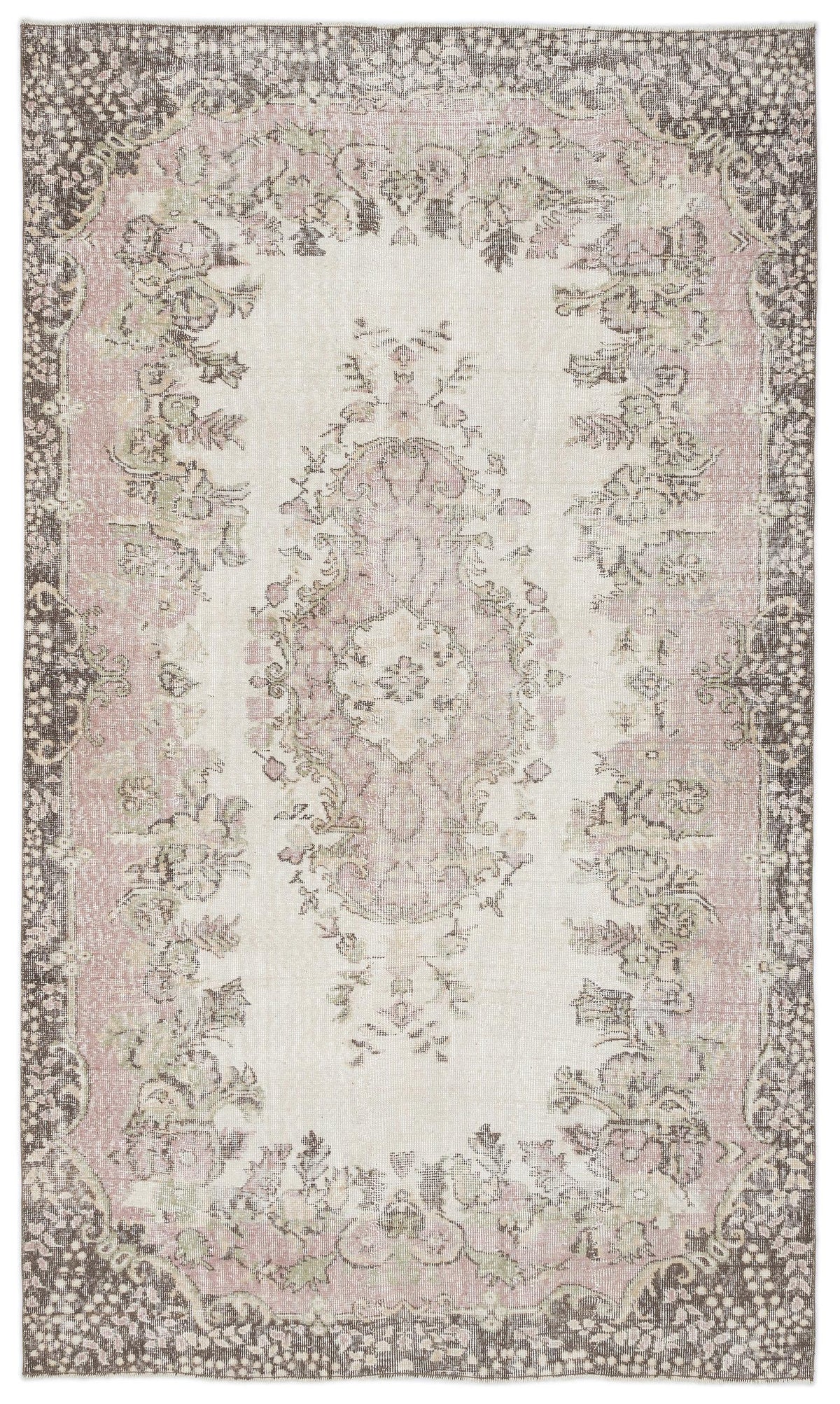 Distressed cream, pink, and charcoal rug with a central floral medallion and ornate border pattern.