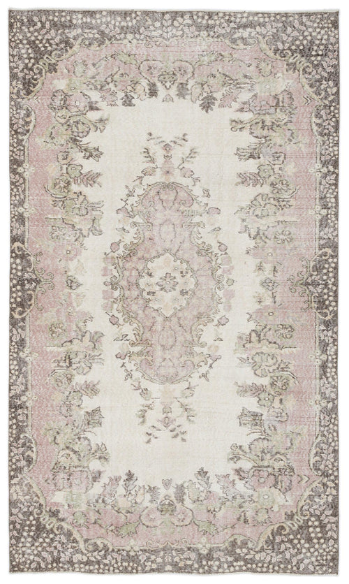 Load image 1 in gallery view. Distressed cream, pink, and charcoal rug with a central floral medallion and ornate border pattern.
