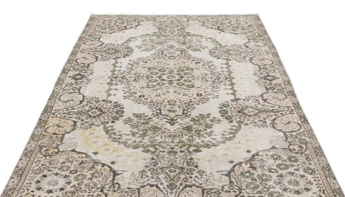 Load image 1 in gallery view. Distressed cream rug with a sage green and brown traditional floral medallion pattern on a white background.