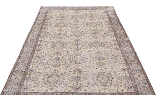 Load image 1 in gallery view. Beige and brown vintage-style rug with a distressed floral medallion pattern and a wide decorative border.