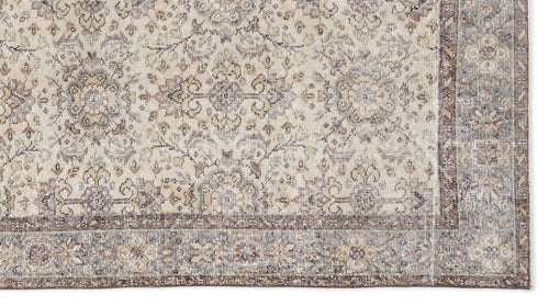 Load image 1 in gallery view. Beige and brown traditional rug with a distressed floral medallion pattern and a wide decorative border.