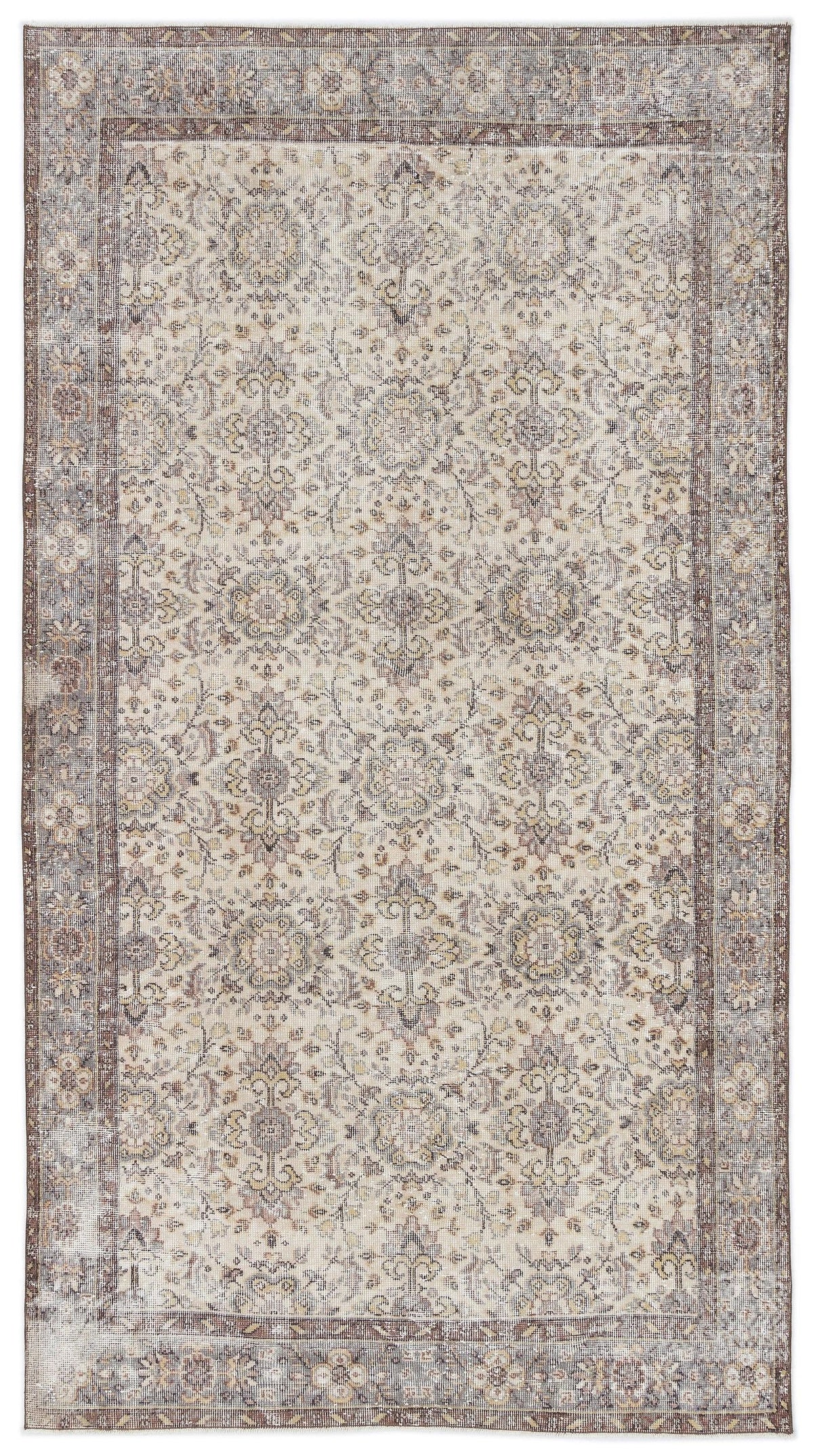 Beige and brown traditional rug with a distressed floral medallion pattern and a wide decorative border.