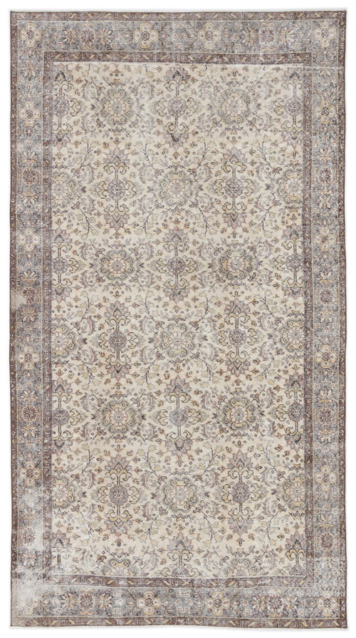 Load image 1 in gallery view. Beige and brown traditional rug with a distressed floral medallion pattern and a wide decorative border.