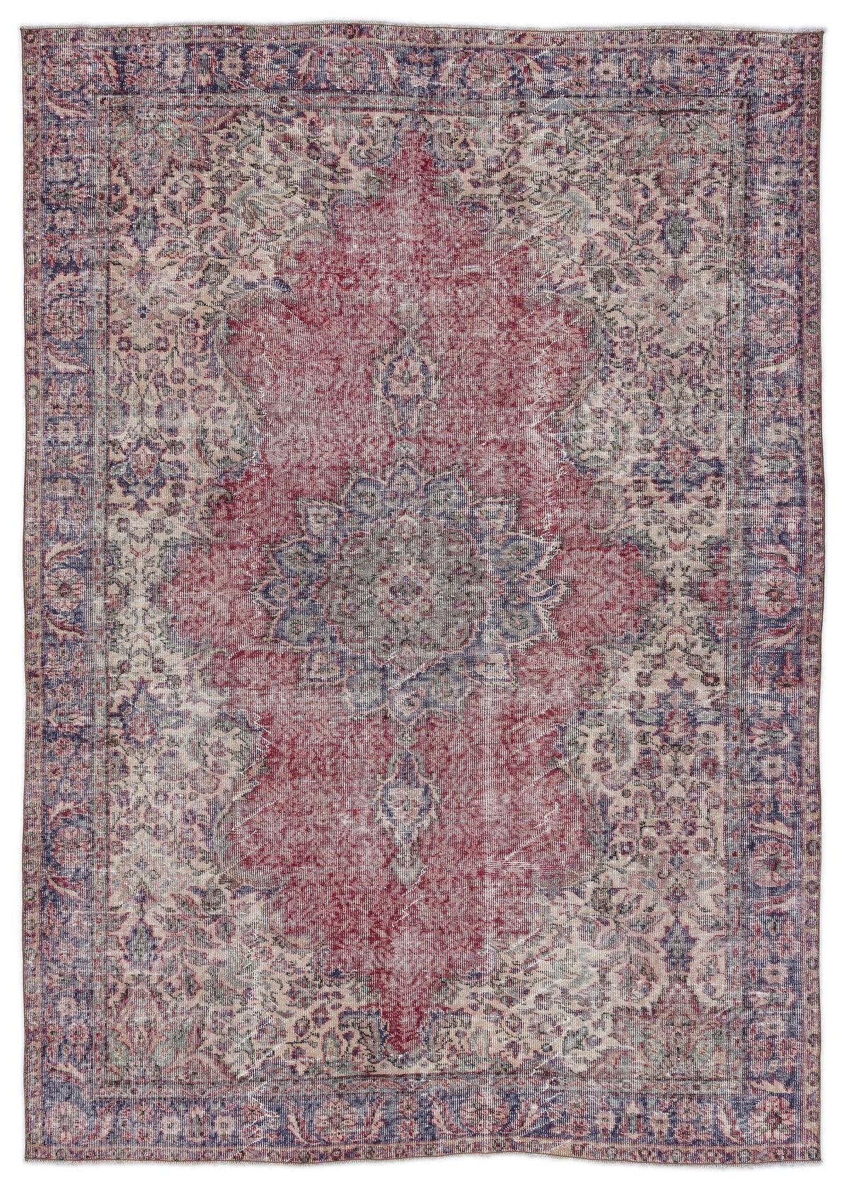 Distressed red, blue, and cream vintage-style rug with a central floral medallion and ornate border.