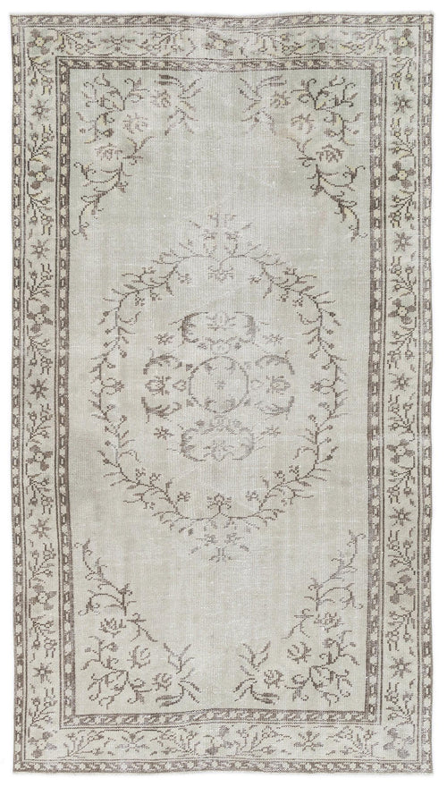 Load image 1 in gallery view. Light gray and taupe vintage-style rug with a central floral medallion and a decorative botanical border.