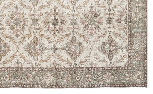 Load image 1 in gallery view. Cream rug with a distressed floral medallion pattern in muted sage, brown, and dusty pink, featuring a wide border.