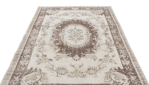 Load image 1 in gallery view. Cream and brown traditional rug with a central floral medallion and ornate border on a white background.