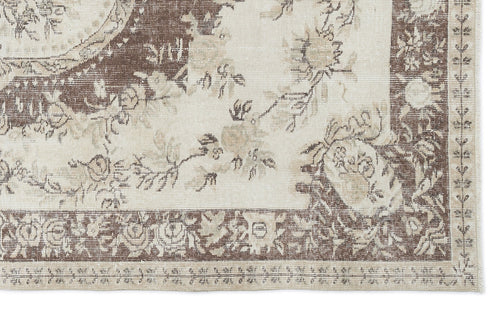 Load image 1 in gallery view. Cream and brown vintage-style rug with a distressed floral medallion pattern and a detailed border.