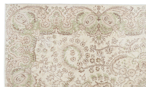 Load image 1 in gallery view. Beige rug with a distressed, faded floral paisley pattern in sage green and brown tones.