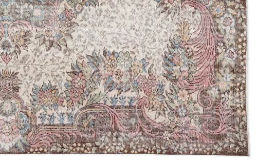 Load image 1 in gallery view. Distressed traditional rug with a cream field, brown border, and floral motifs in muted pink, blue, and green.