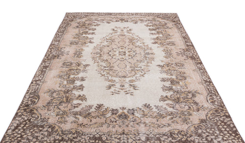 Load image 1 in gallery view. Beige and brown vintage-style rug with a central floral medallion and ornate border on a white background.