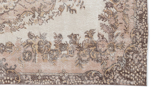 Load image 1 in gallery view. Beige and brown distressed rug with a traditional floral medallion pattern and a detailed border.