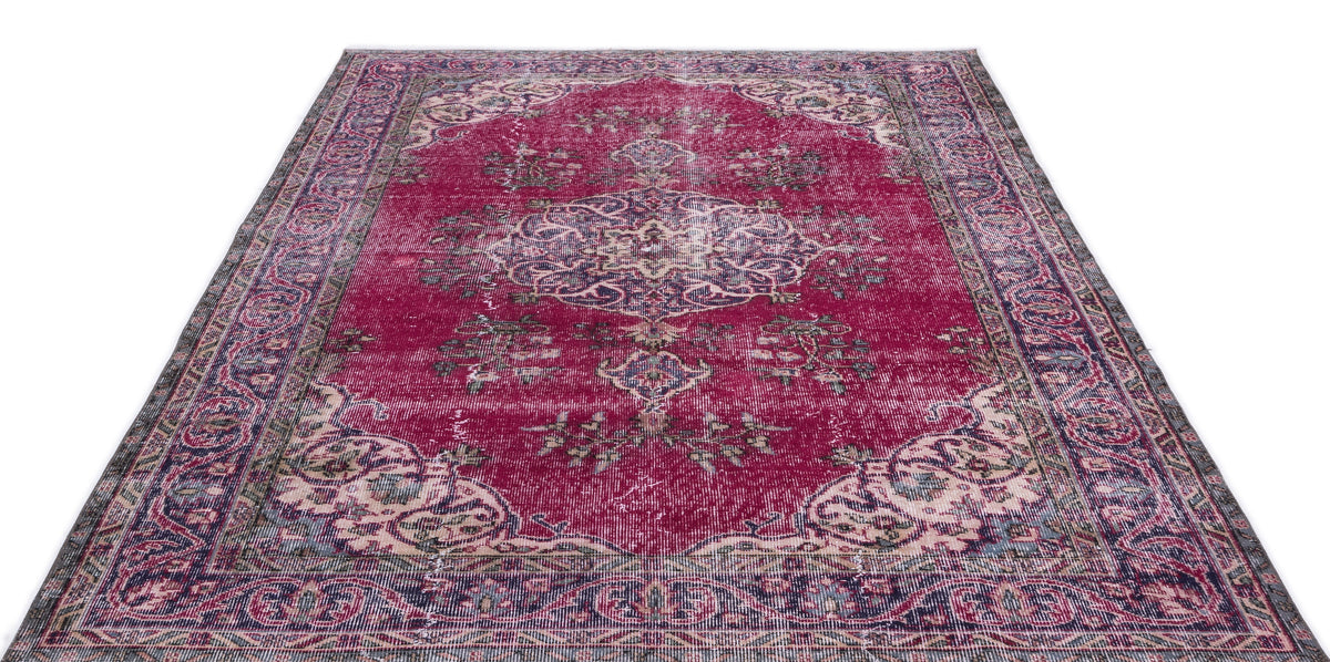 Magenta distressed Persian-style rug with a central medallion and ornate floral border on a white background.